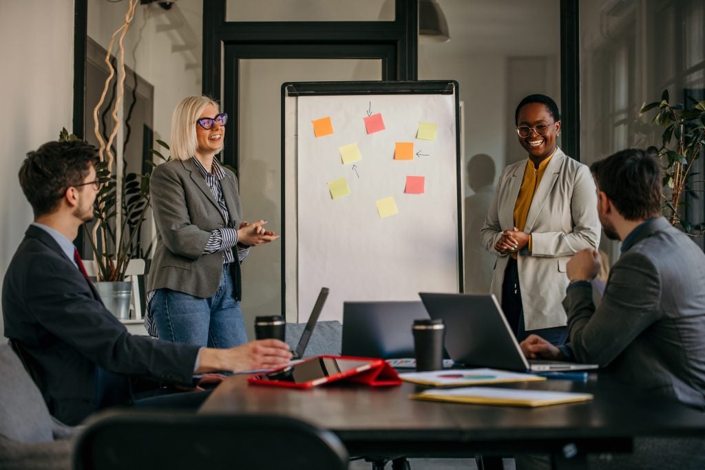 Inclusive corporate culture on display as a varied group of professionals in a conference room, exchanging insights during a collaborative meeting