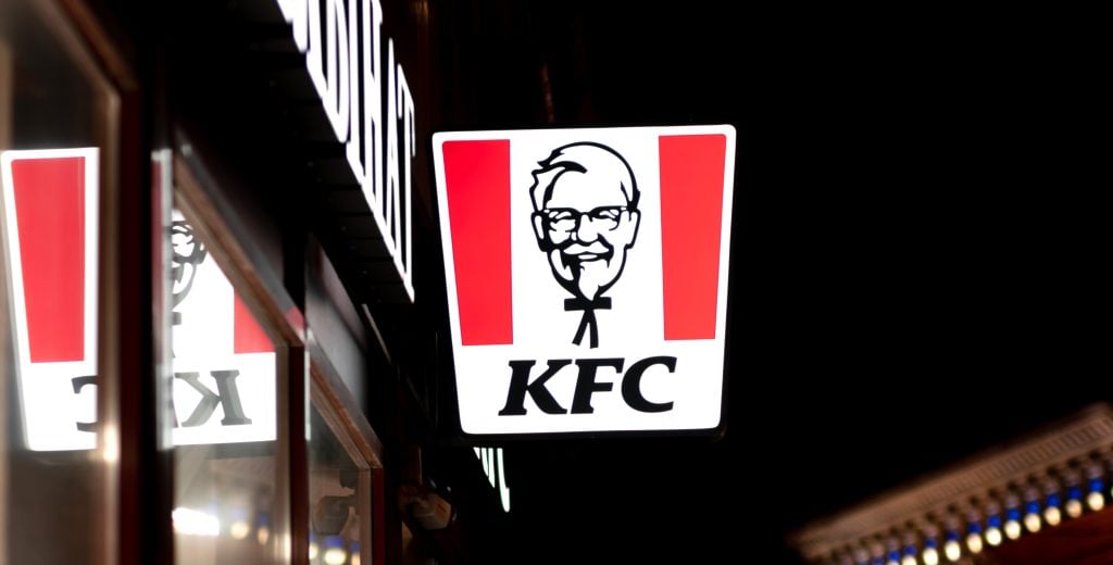 Signboard of KFC restaurant luminous in the night city background