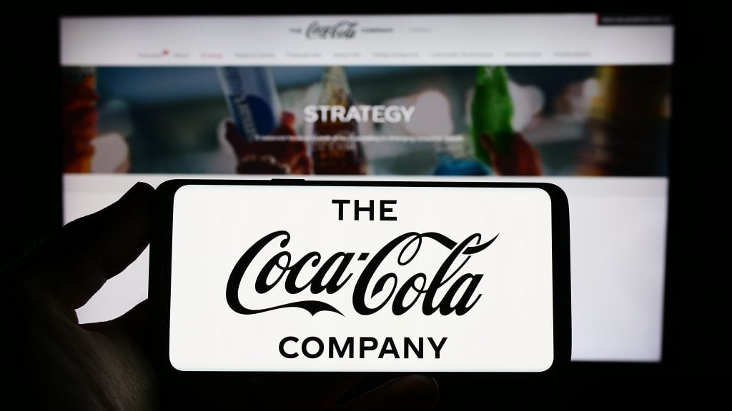 The Coca-Cola Company on the screen is in front of a website.