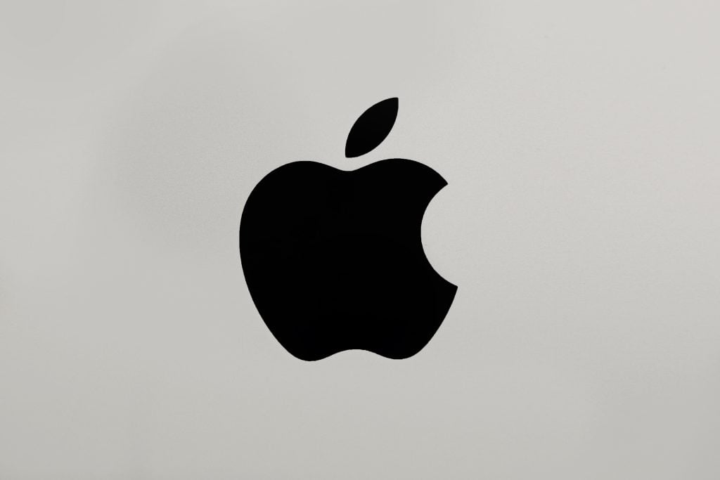 black Apple logo on brushed aluminium background. 